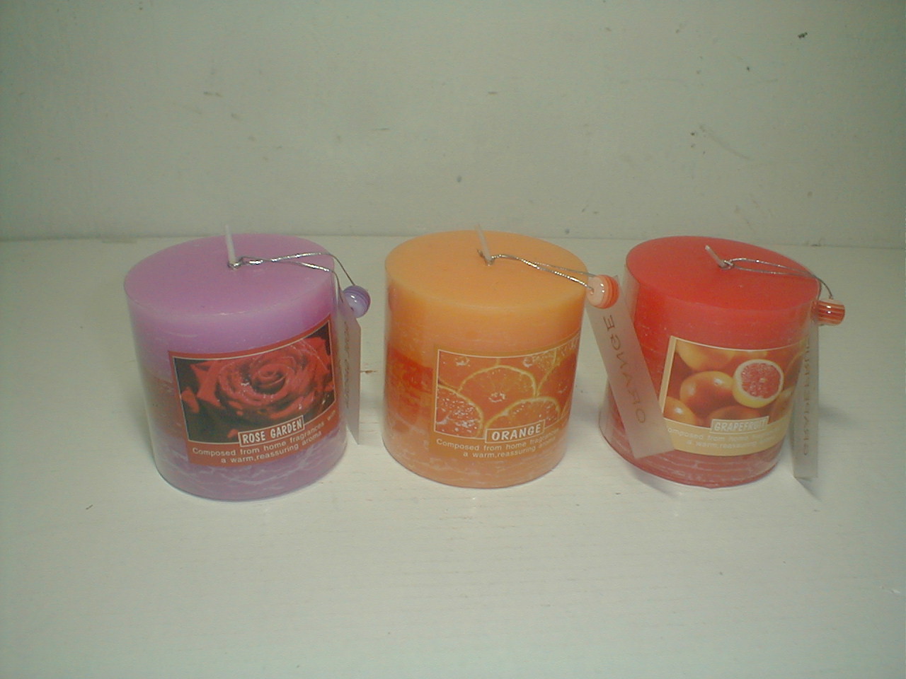 3x3" Purple,orange & red scented pillar assorted candle packed by pvc sheet and printed label