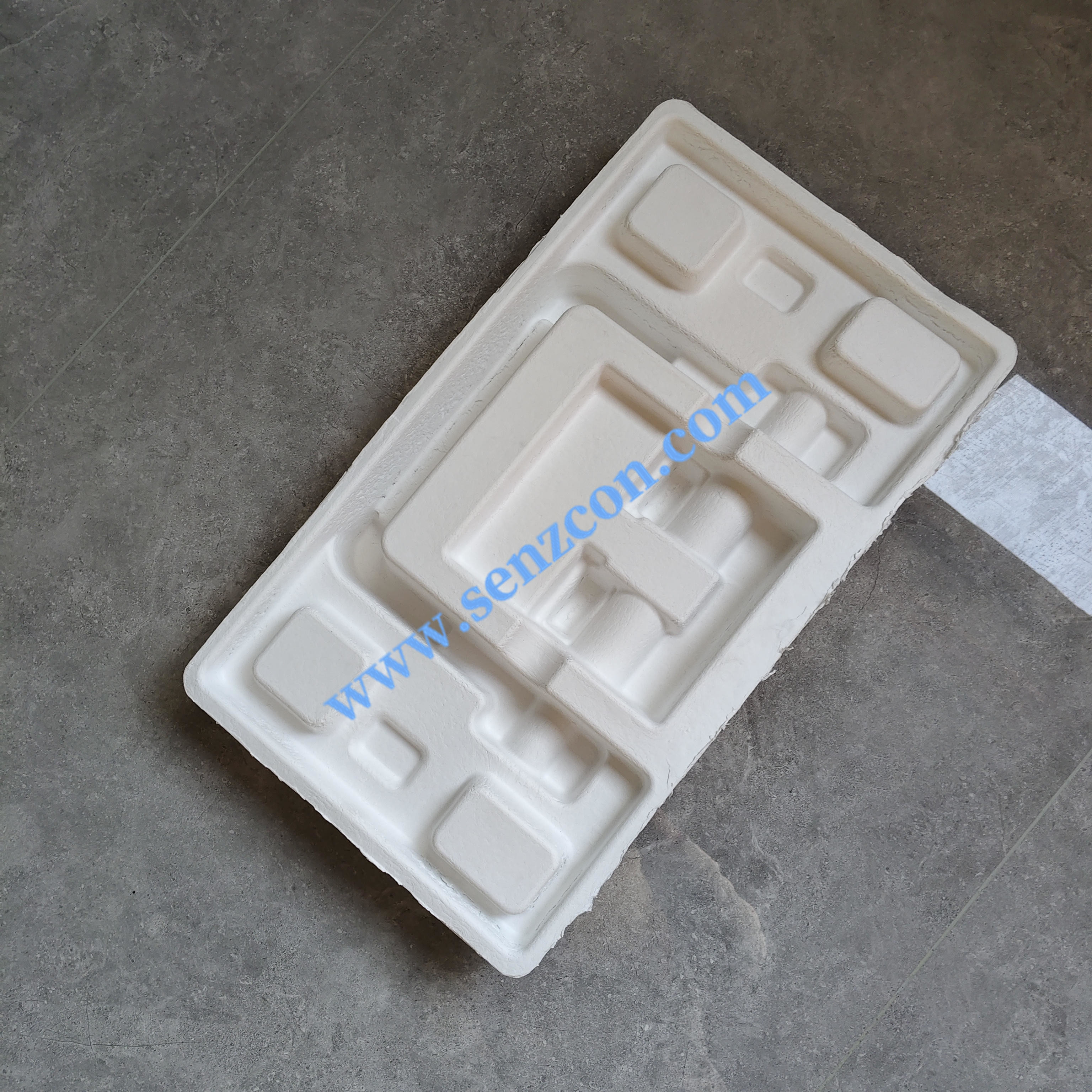 The dry-pressed pulp molded packaging made of white sugarcane pulp, which is customized by the manufacturer for fitness equipment.