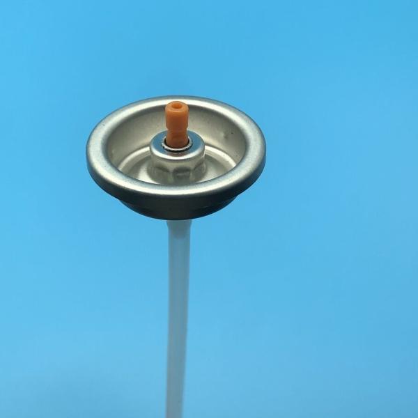 Exploded view of aerosol valve components and mounting cup