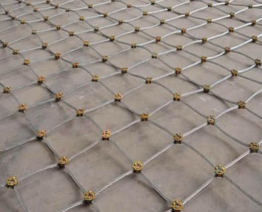 A large piece of slope protection rope mesh is on the floor.