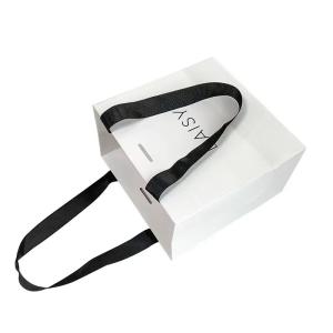 China Embossing Ribbon Handle Cosmetic Paper Bags White Paper Carrier Bags wholesale