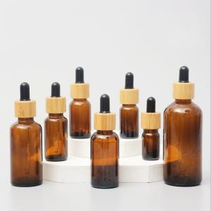 China Glossy Amber Color Bamboo Essential Oil Glass Dropper Bottle Wood Cap Glass Cosmetic Containers wholesale