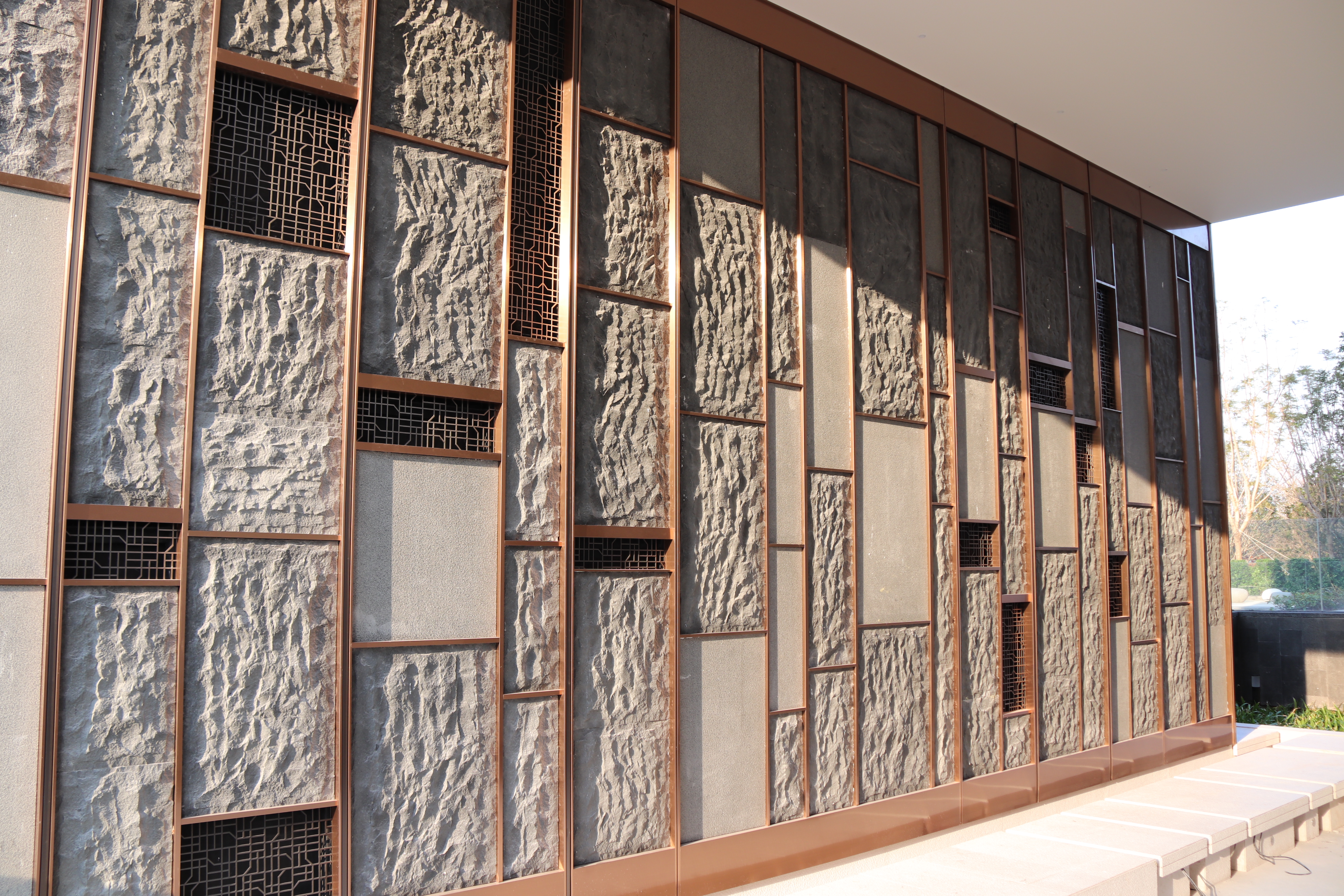 Faux Stone Wall Cladding And Installed Within Stainless Steel Frame Surrounded