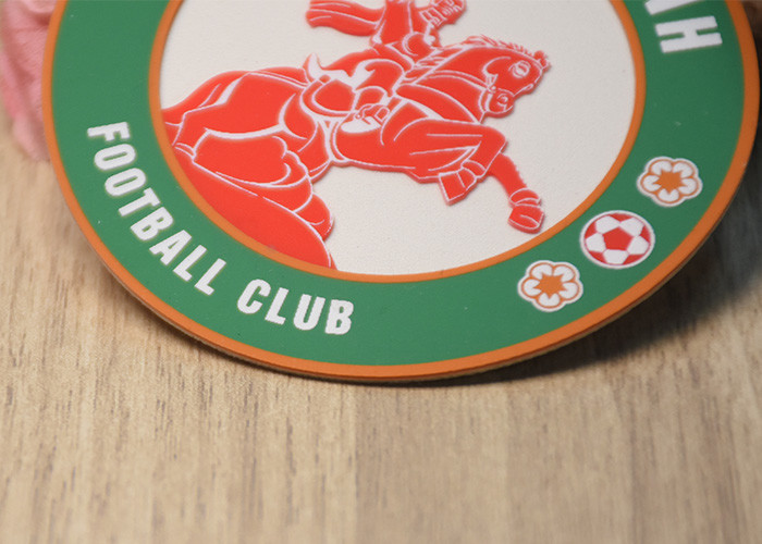 Raised Silicone Logo screen printed patches On A White Microfibre Background For Garments