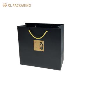 China Recyclable Kraft Paper Packaging Bags Cosmetic Clothing Paper Box With Logo wholesale