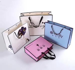 China Cosmetics Three Sections Rope Apparel Paper Bag Ivory Board Boutique Packaging Bags wholesale