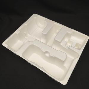 China OEM manufacturers customize pulp molded packaging bases for small household appliance fascia guns. These are made of white plant fibers through dry wholesale