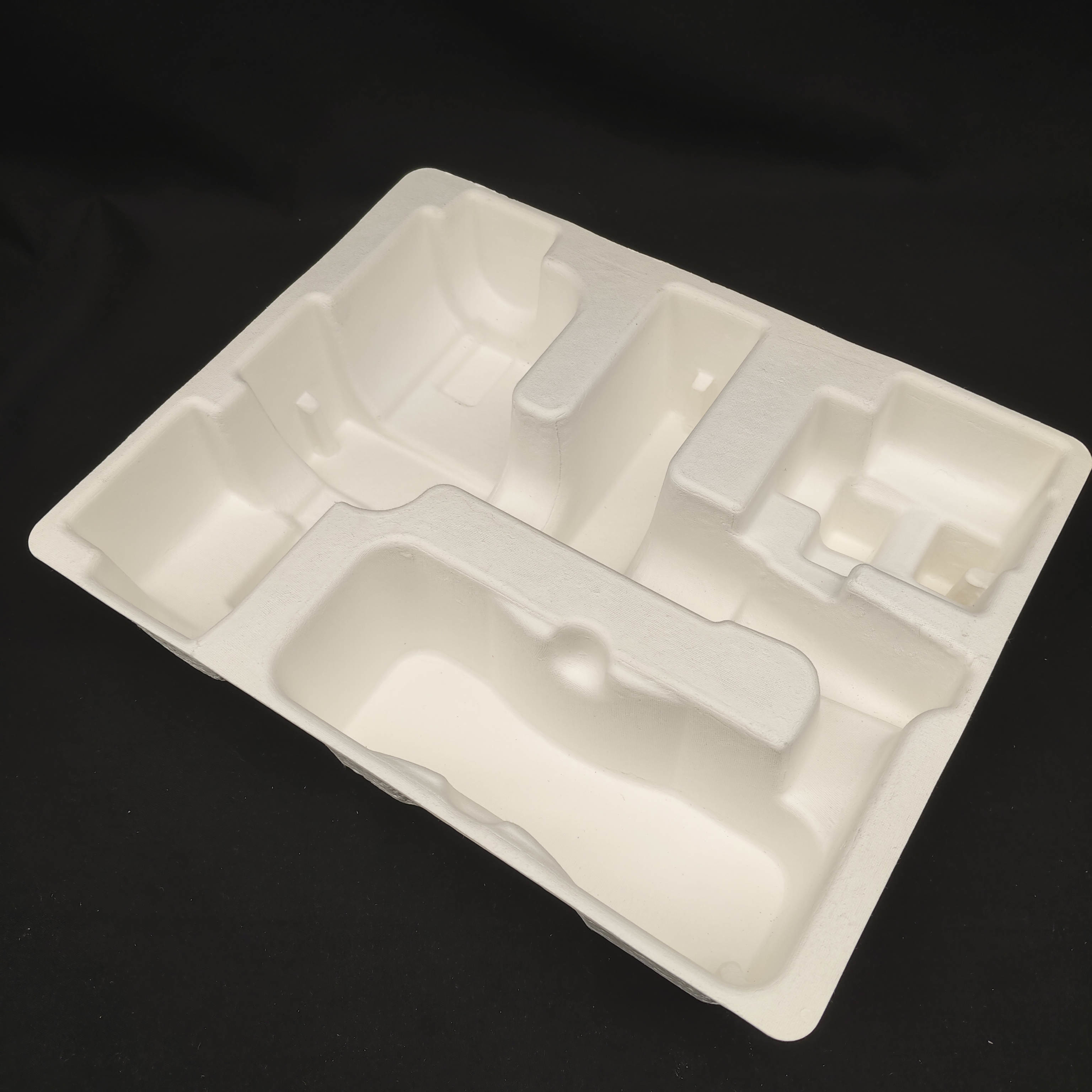 OEM manufacturers customize pulp molded packaging bases for small household appliance fascia guns. These are made of white plant fibers through dry